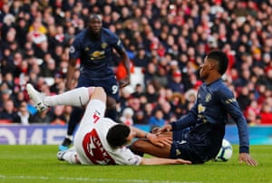Rashford and Xhaka collide.