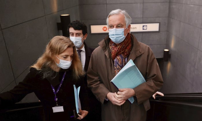 Michel Barnier (right) coming out of a metro station on his way to a meeting in Brussels earlier.