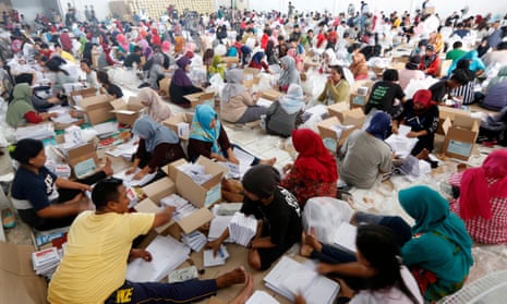 Hundreds of electoral commission workers prepare ballot papers for the upcoming general elections in Indonesia.