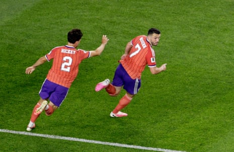 John McGinn celebrates scoring their first goal with Aaron Hickey