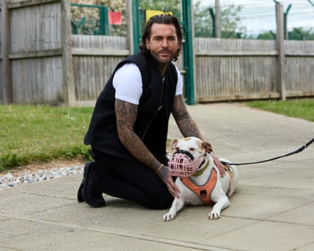Pete Wicks and muzzled dog