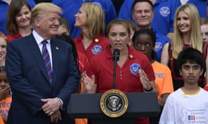 Trump listens as beach volleyball star Misty May-Treanor speaks at the White House Sports and Fitness Day event.