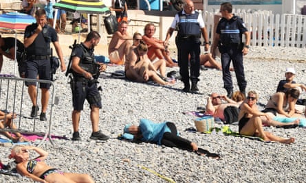French police make woman remove clothing on Nice beach following burkini  ban | France | The Guardian