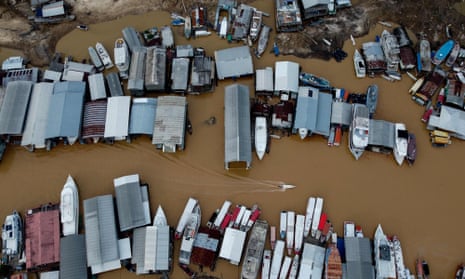 Floating houses and boats are seen stranded at the Marina do Davi, a docking area of the Negro river, city of Manaus in northern Brazil on 16 October 2023.
