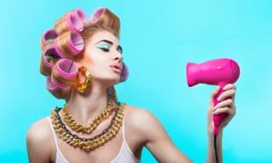 Glamorous woman blow drying her hair