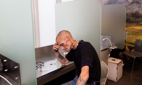 A drug user after injecting heroin in his arm at The Cloud fixing room facility in Copenhagen, Denmark.