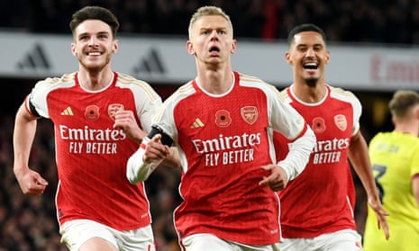 Oleksandr Zinchenko of Arsenal celebrates with Declan Rice and William Saliba after scoring the team's third goal against Burnley