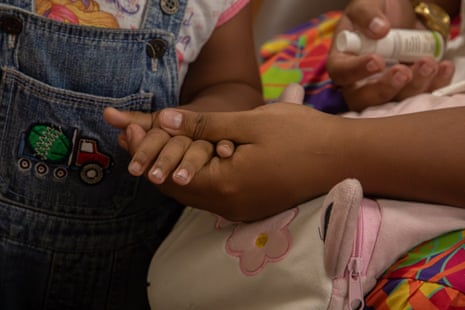 A mother and child hold hands, an HIV survivor family in Fiji