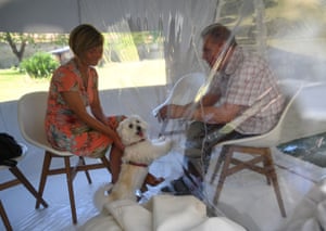 A woman visits her husband in a retirement home in Bourbourg, France, where a double entry bubble has been installed to allow visits without risk of contamination
