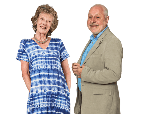 A smiling woman in a blue tie-dye dress and a smiling man in a light coloured suit and shirt