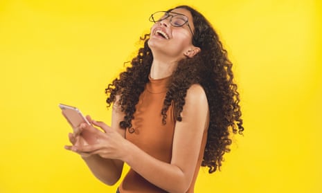 Happy teenager on yellow background with her smart phone