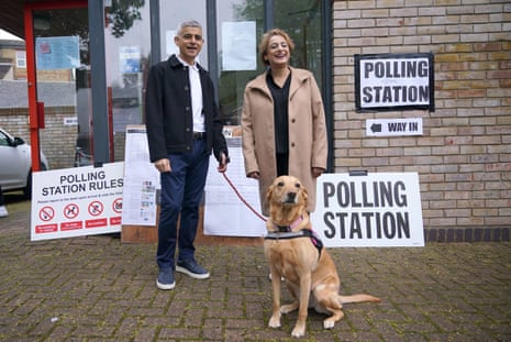 Sadiq Khan, his wife Saadiya Khan and and their dog Luna at the polling station at St Alban's Church, in south London.