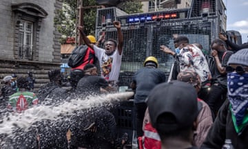 Nairobi, Kenya Protesters climb a police water cannon truck.