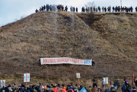 Activists raise a banner during a protest against the Dakota Access pipeline in November.