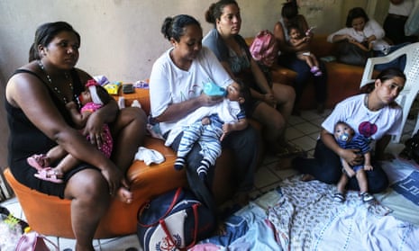 Infants born with microcephaly are held by mothers and family members at a meeting for mothers of children with special needs in Recife, Brazil. 
