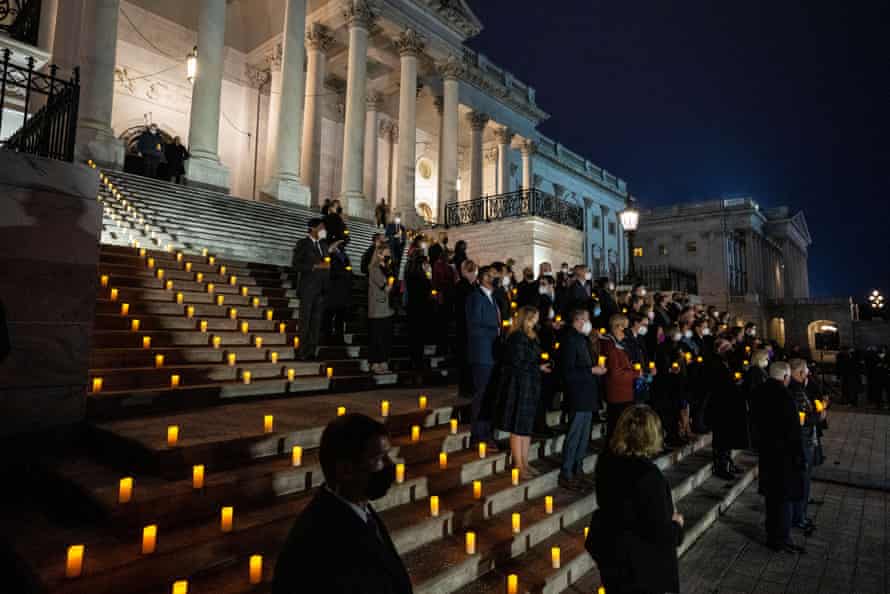 Members of Congress and staff participate in a prayer vigil on the east front of the Capitol.