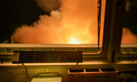 View from ship’s bridge of explosive flash of orange at night