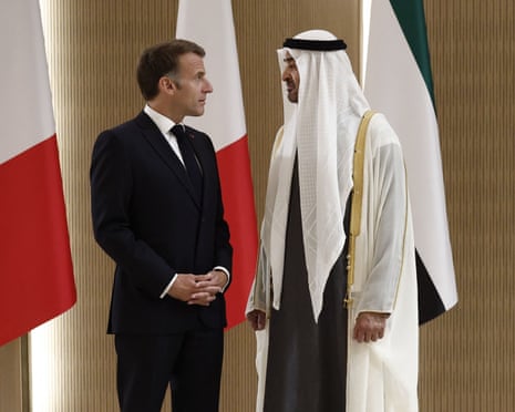 Macron and Sheikh Mohamed bin Zayed Al Nahyan converse closely between national flags