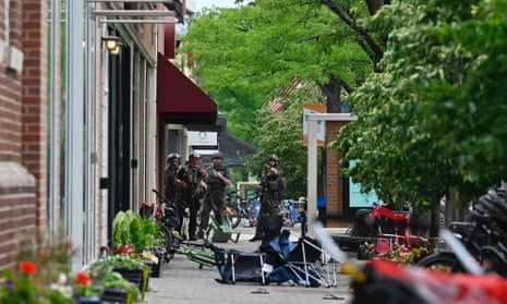 Police search the downtown area of the Chicago suburb of Highland Park.