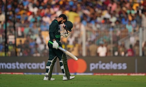 Khan leaves the field after being dismissed.