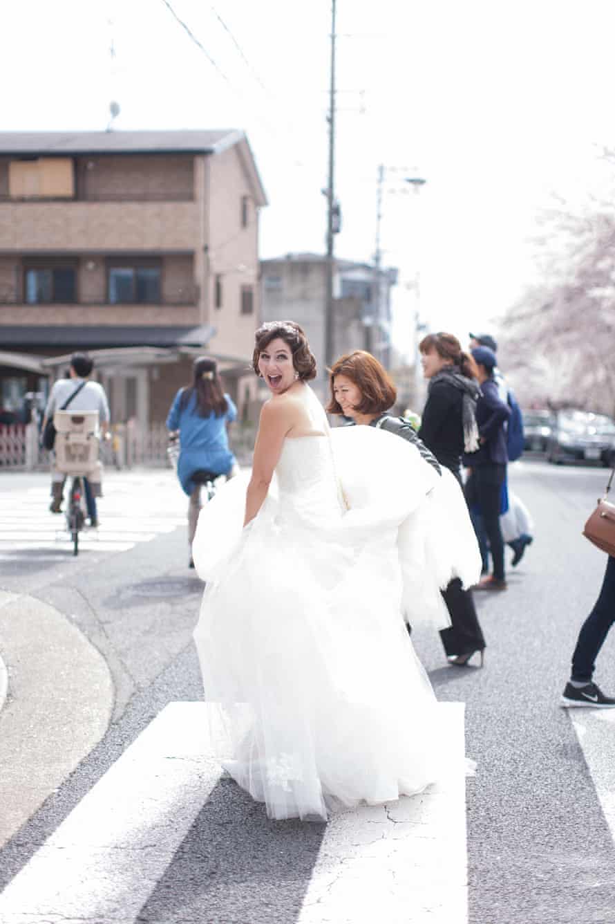 Naomi Harris on a zebra crossing in Japan in a wedding dress