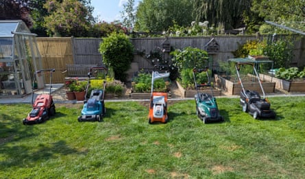 Five lawnmowers in a row on a patchy lawn