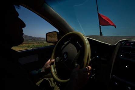Landmine deminer Hoshyar Ali drives to help a man after receiving a request to help remove landmines from the farmers property near Penjwen, Iraqi Kurdistan. The red flag indicates his vehicle contains explosives.