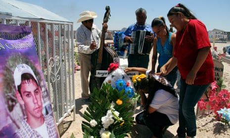 Relatives of Sergio Hernandez mourn at his grave in a cemetery in Ciudad Juarez. The shooting took place in June 2010 on the border between El Paso and Ciudad Júarez.