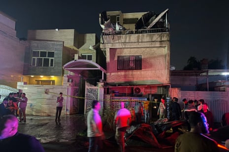 People inspect the damage to their homes, after a drone attack struck their neighbourhood on Palestine Street, in eastern Baghdad, Iraq.