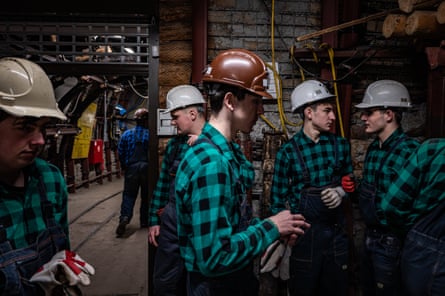 a group of student miners during a class in a tunnel-laboratory at the Technical School Complex wearing hard hats.