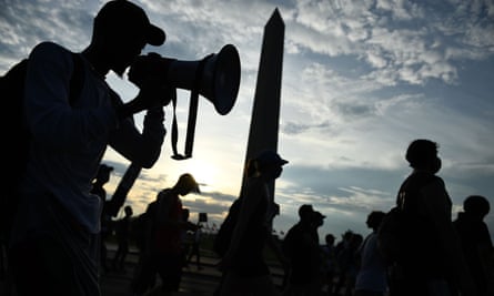Demonstrators march past the Washington Monument in protest at the death of George Floyd while in police custody.