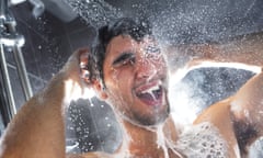 Man in shower, rinsing shampoo from hair (posed by model)
