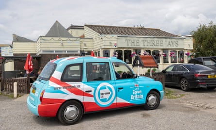 A taxi with Reform UK branding in Clacton.