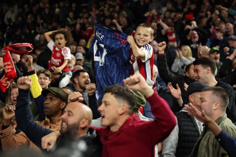An Arsenal fan displays a Declan Rice shirt in the stands after the victory at Fulham.