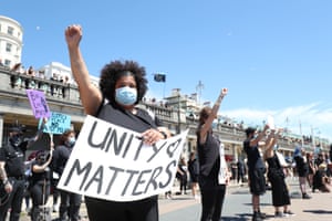 Protesters take part in a silent vigil on Madeira Drive/Brighton Pier.