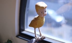 Wooden toy bird with human head