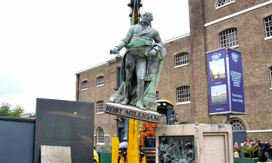 Municipal workers remove the statue of slave-owner and slave merchant Robert Milligan after a petition in West India Quay district of London