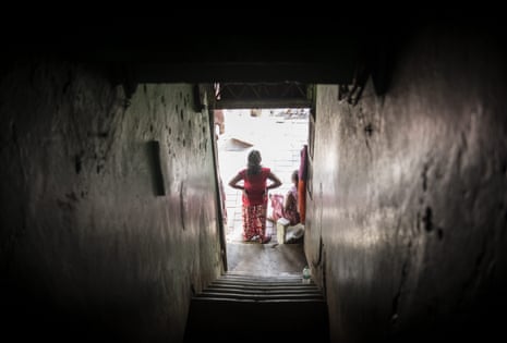 A woman standing in a doorway with her hands on her hips