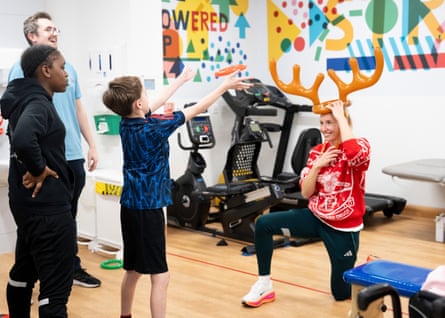 Leah Williamson, the Arsenal women and England Lionesses captain, wears antlers and plays hoopla at Great Ormond Street