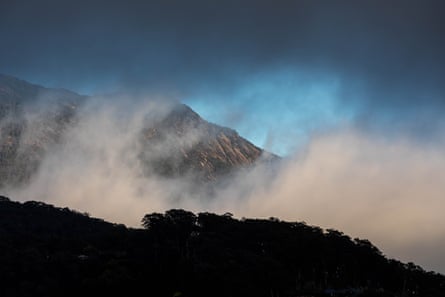 Low clouds swirl over the mountains behind the property where Dezi Freeman was living