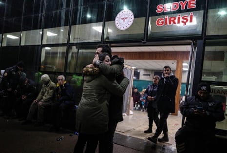 People react in front of a hospital in Iskenderun district of Hatay, Turkey.