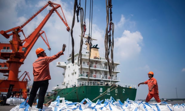 Workers unload freight at Zhangjiagang in China’s eastern Jiangsu province