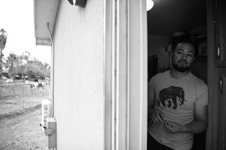A man stands in his doorway