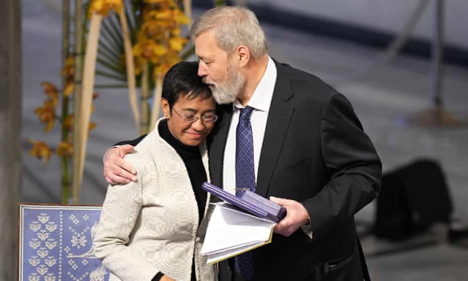 The Nobel peace prize winners, Dmitry Muratov, right, and Maria Ressa, embrace during the Oslo ceremony