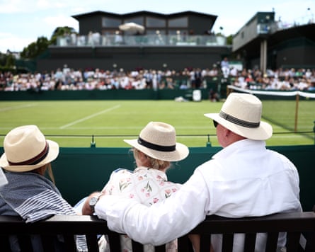 Spectators watch connected nan retired courts astatine Wimbledon