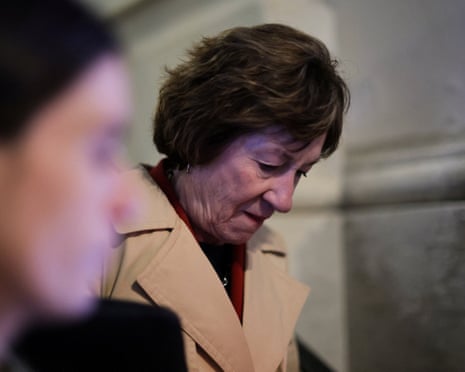 Woman looks towards ground on steps of Capitol
