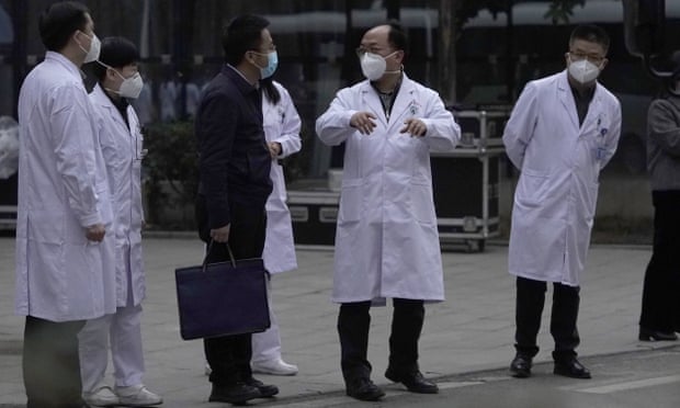 Chinese medical staff outside the Hubei Province Xinhua hospital in Wuhan as the WHO team leaves.