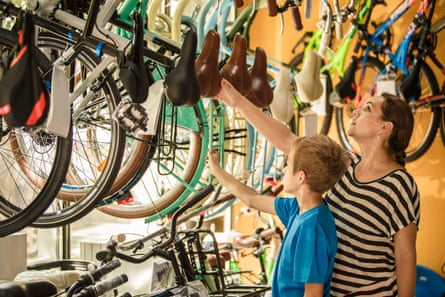 Women and son browse bikes in a cycle shop