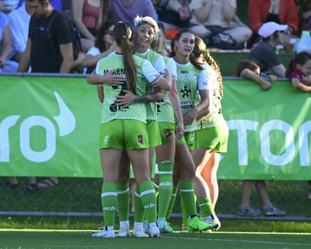 Canberra United players observe a goal.