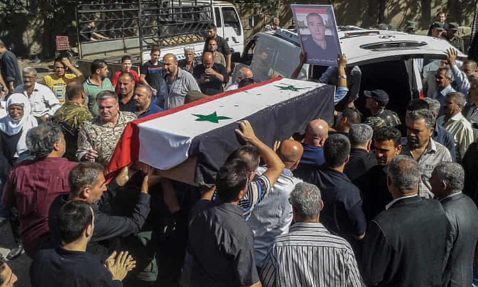 Mourners carry coffins of three of the 216 who were killed by Isis fighters in Sweida province.
